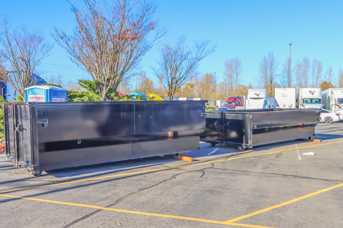 Professional dumpster rental service with roll-off container on residential driveway in Moapa Valley